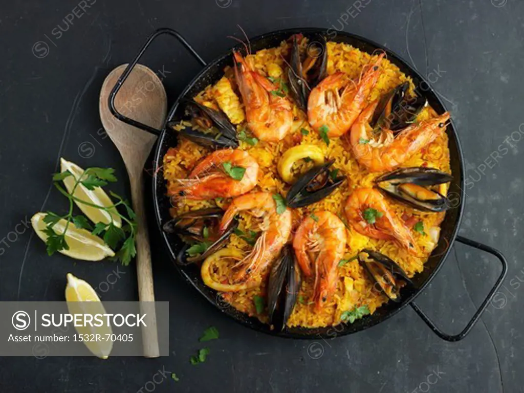 Paella decorated with mussels and prawns