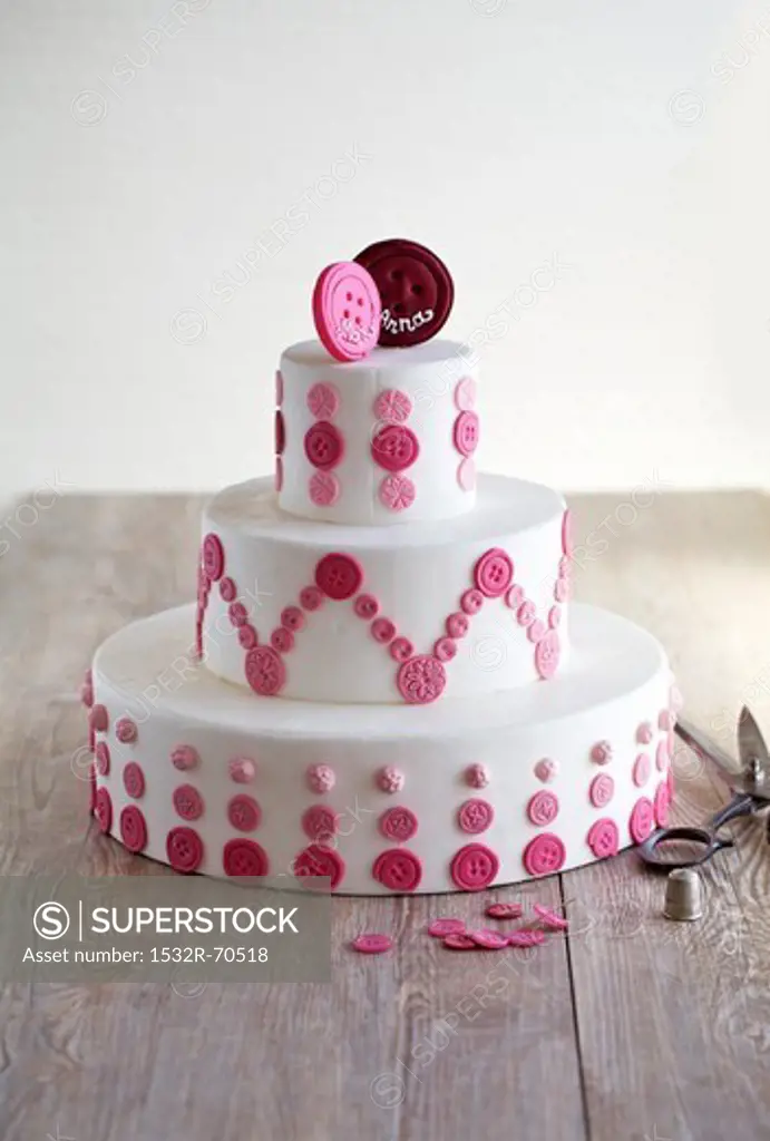A wedding cake with a button design