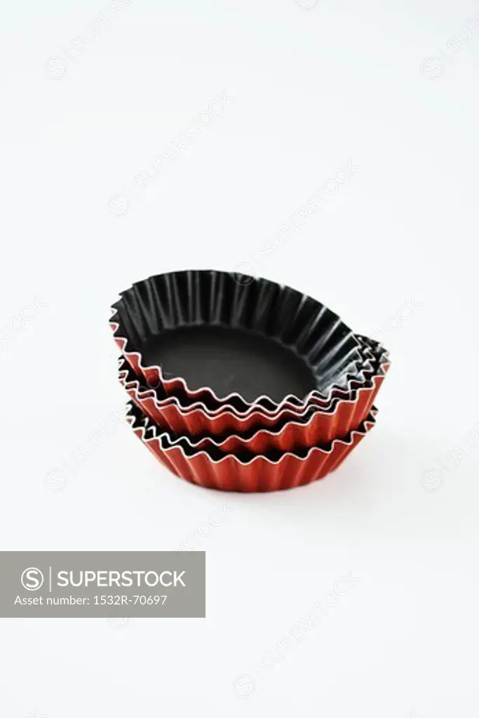 A stack of tartlet tins against a white background