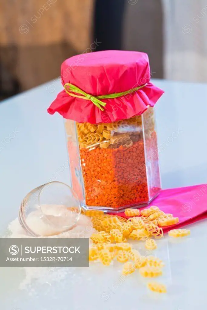 Dried pasta and red lentils in a storage jar as a gift