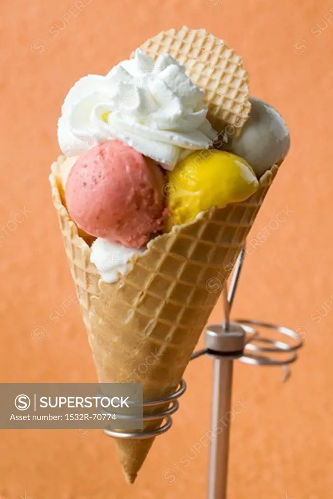 Fruit ice cream with cream in a wafer cone