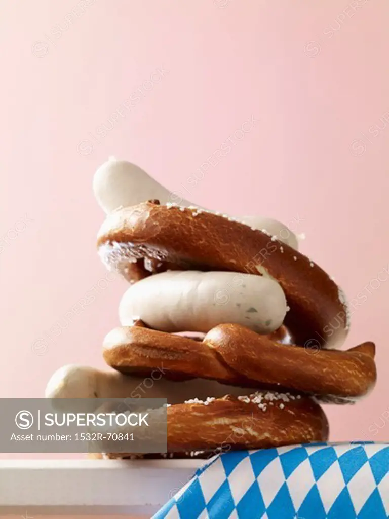 A stack of pretzels and white sausages