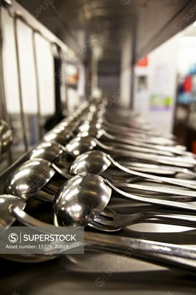 Lots of ladles in the kitchen of a restaurant