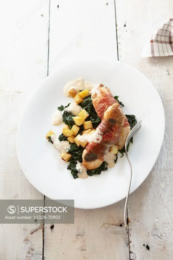 Guinea fowl wrapped in bacon with spinach