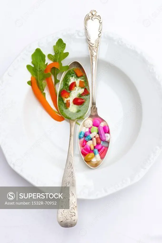 A spoonful of herb sauce with peppers and a spoonful of vitamin pills