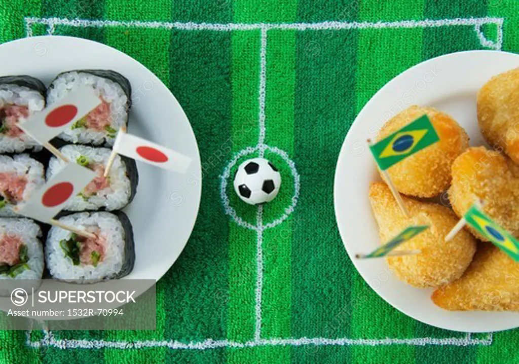 Sushi (Japan) and salgadinhos (Brazil) with football-themed decoration