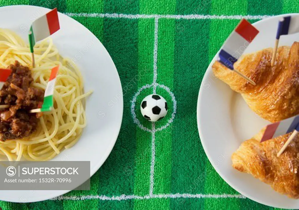 Spaghetti (Italy) and croissants (France) with football-themed decoration