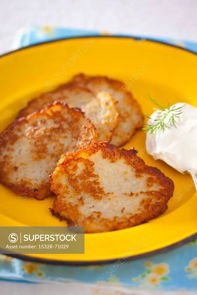 Potato fritters with a blob of sour cream