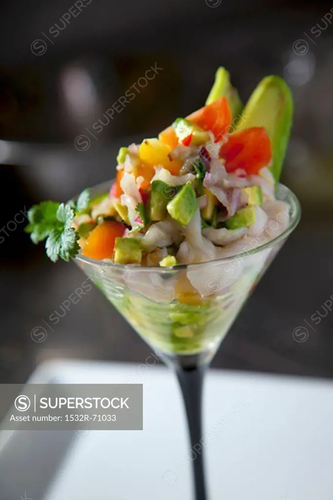 Ceviche with avocado in a stemmed glass