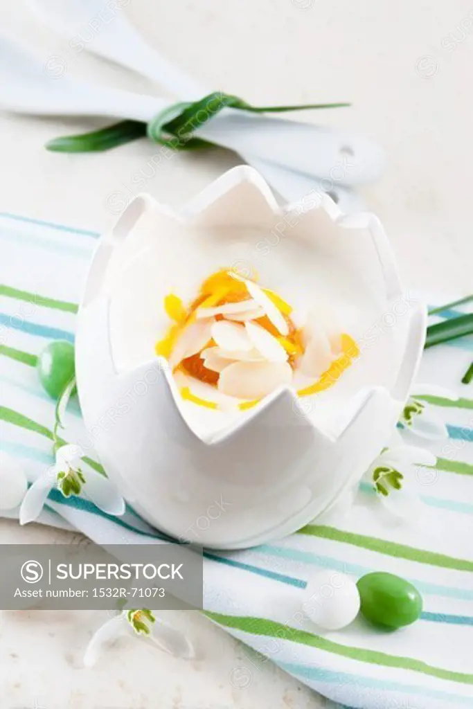 A yoghurt dessert with passion fruit sauce in an Easter porcelain bowl