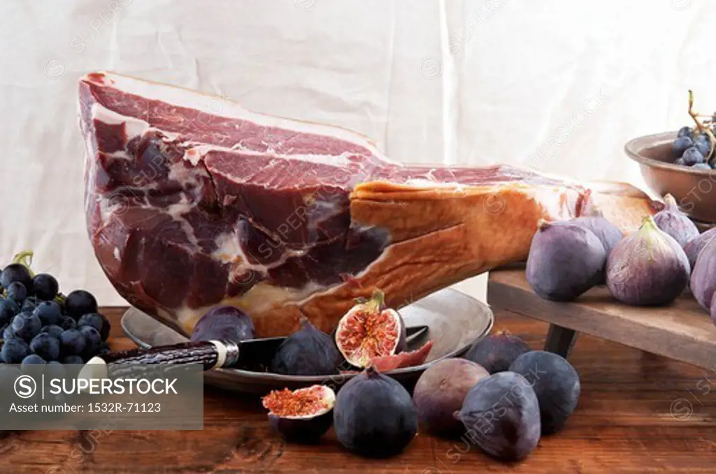A leg of Parma ham, figs and blue grapes