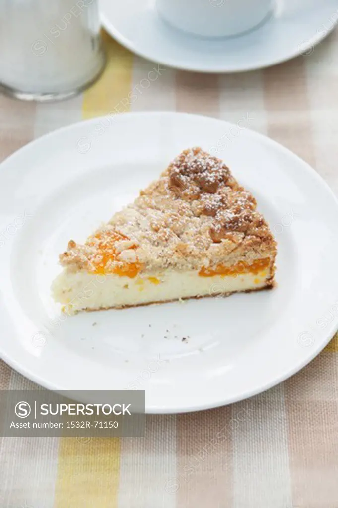 A slice of cheesecake with Mirabelle plums and crumble