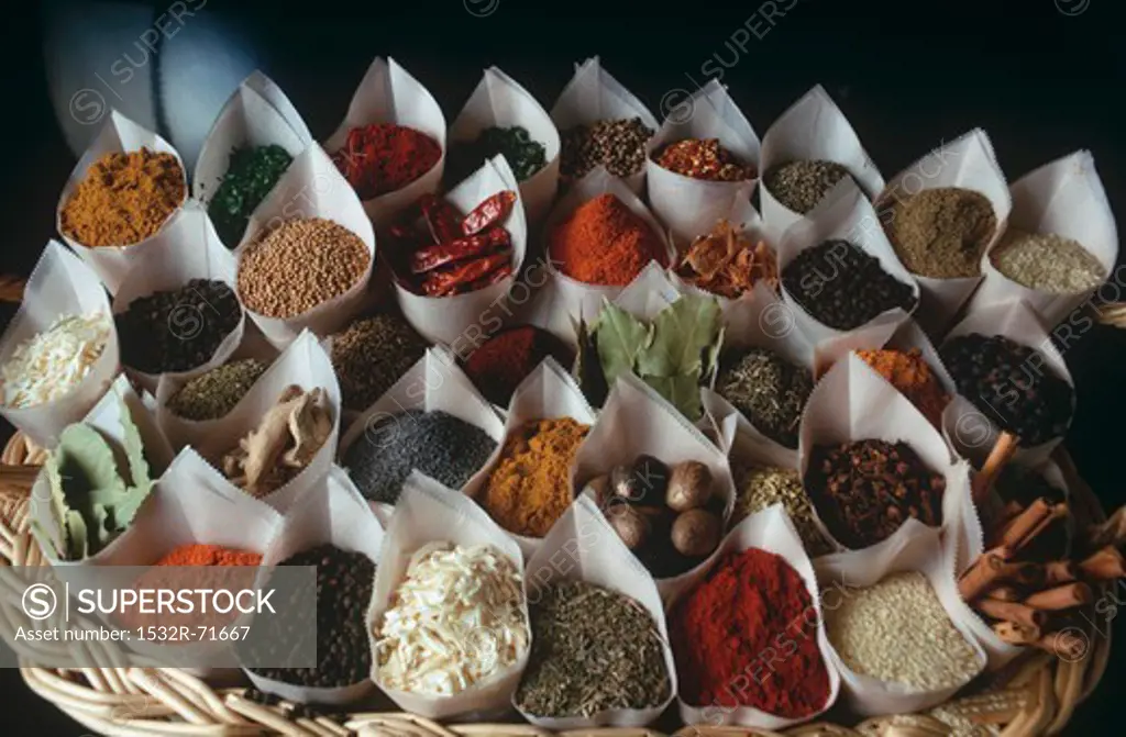 A basket of paper cones holding assorted spices