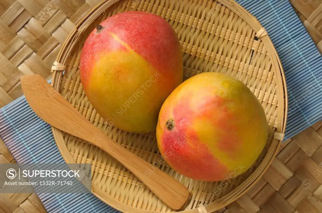 Two mangos in a basket