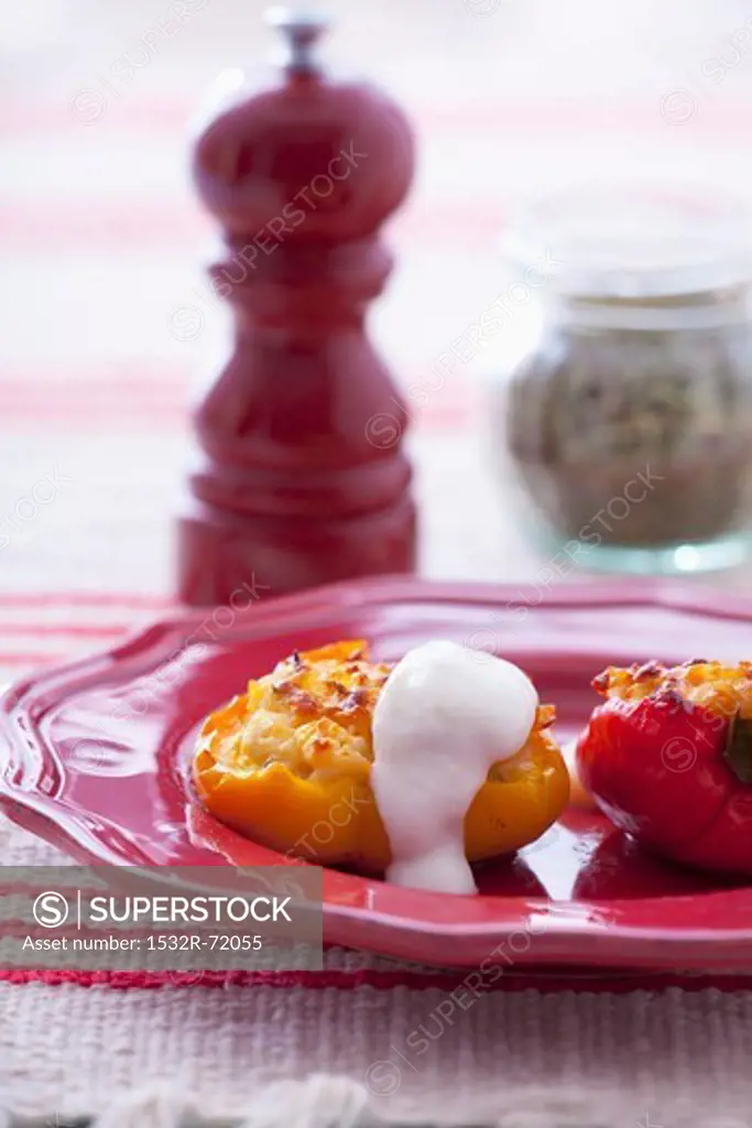 Peppers stuffed with rice and cheese filling, sour cream on top