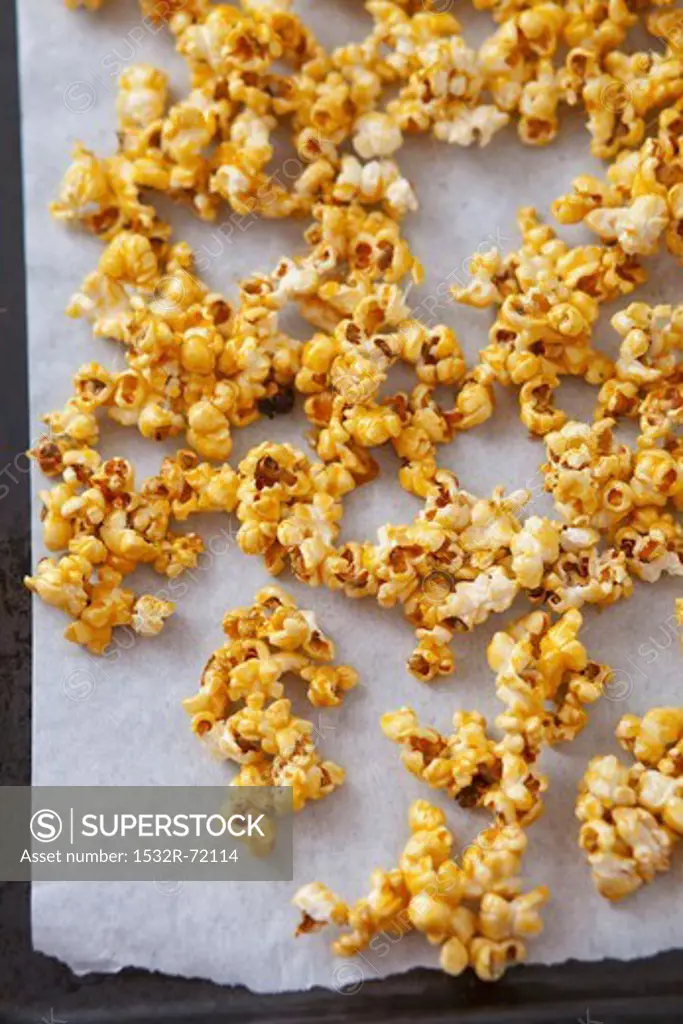 Caramelised popcorn on a baking tray