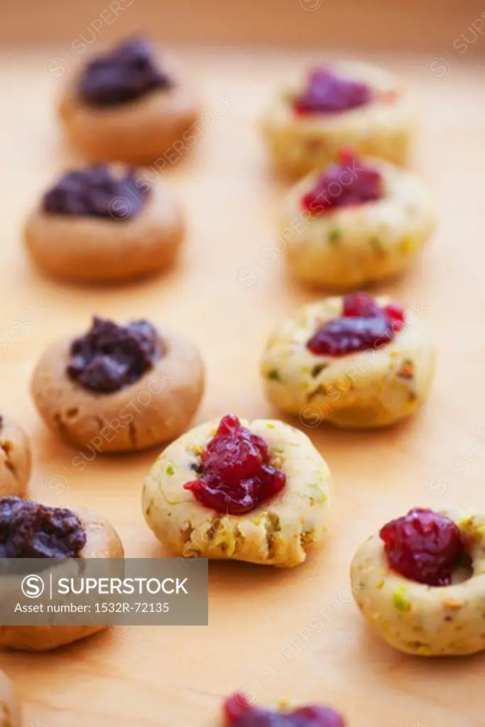 Unbaked chocolate and pistachio biscuits with jam