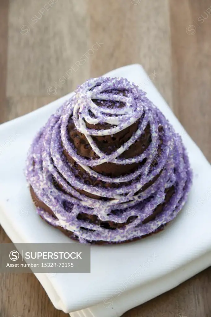Chocolate cake with squash and ginger decorated with purple sugar