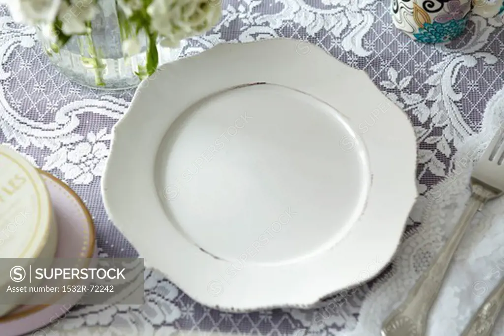 A white plate on a lace cloth