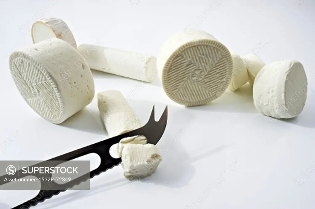 Assorted types of fresh goat's cheese with a cheese knife