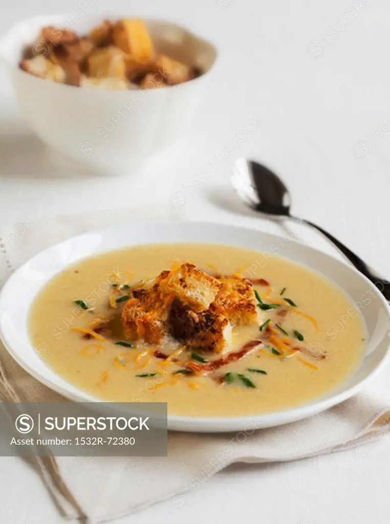 A Bowl of Apple Cheddar Soup with Bacon and Croutons