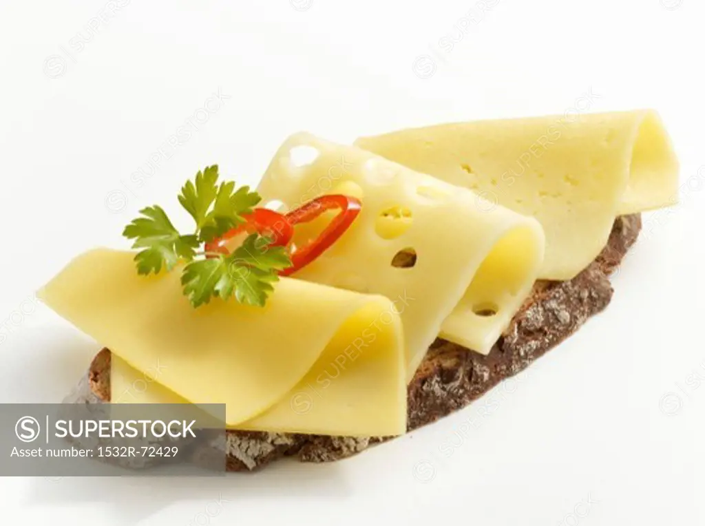 A slice of bread topped with sliced cheese