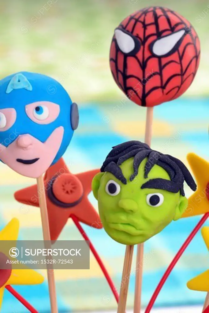 Cake pops decorated to look like superheroes