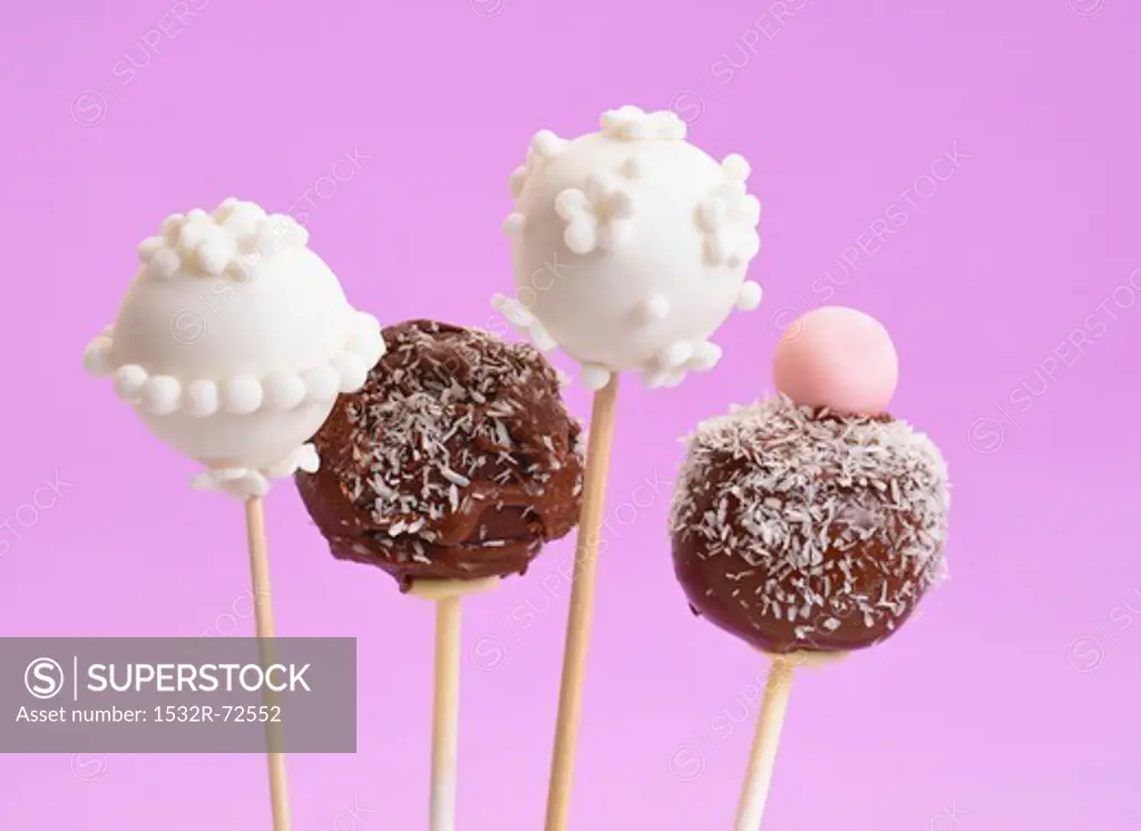 Vanilla and chocolate cake pops against a purple background