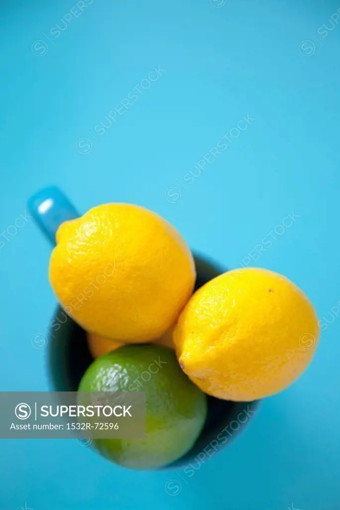 Lemons and a lime in a cup