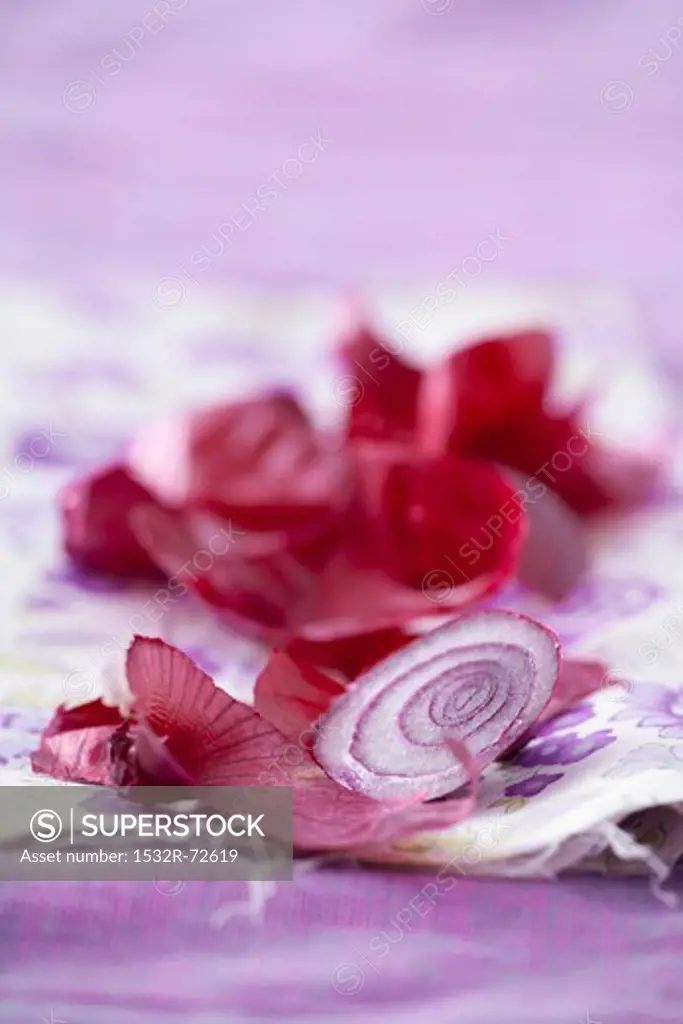 Slices of red onion and red onion peelings