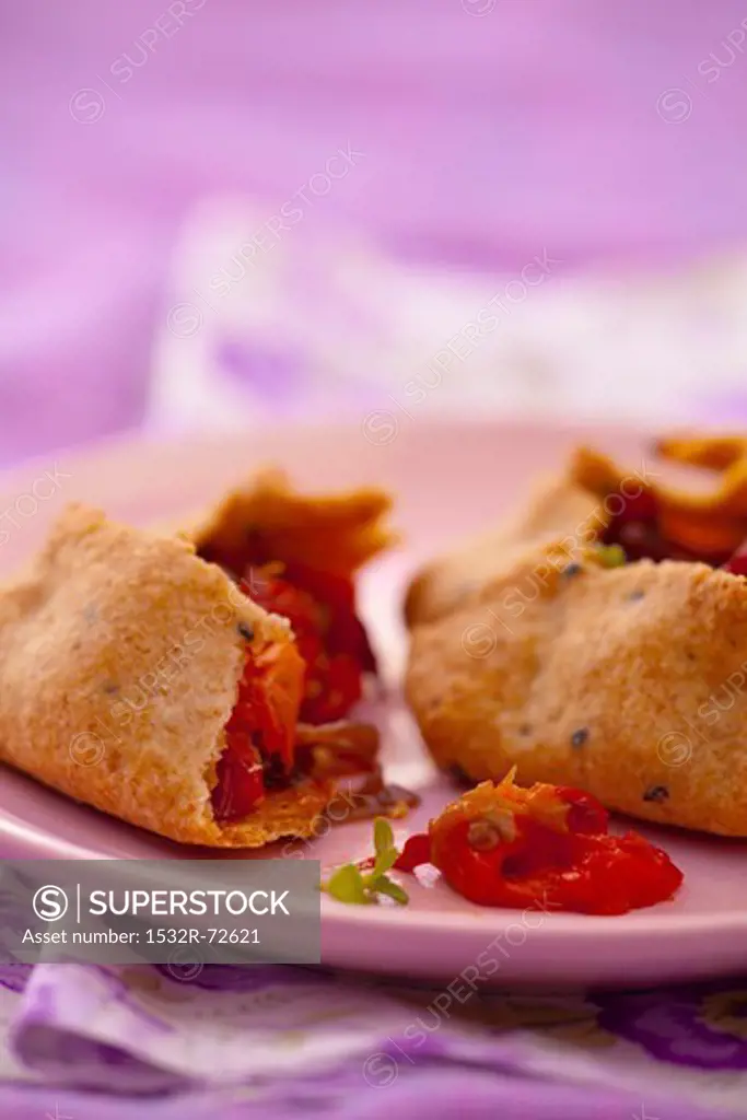 Wholemeal pastry parcels with pepper and onion filling, halved