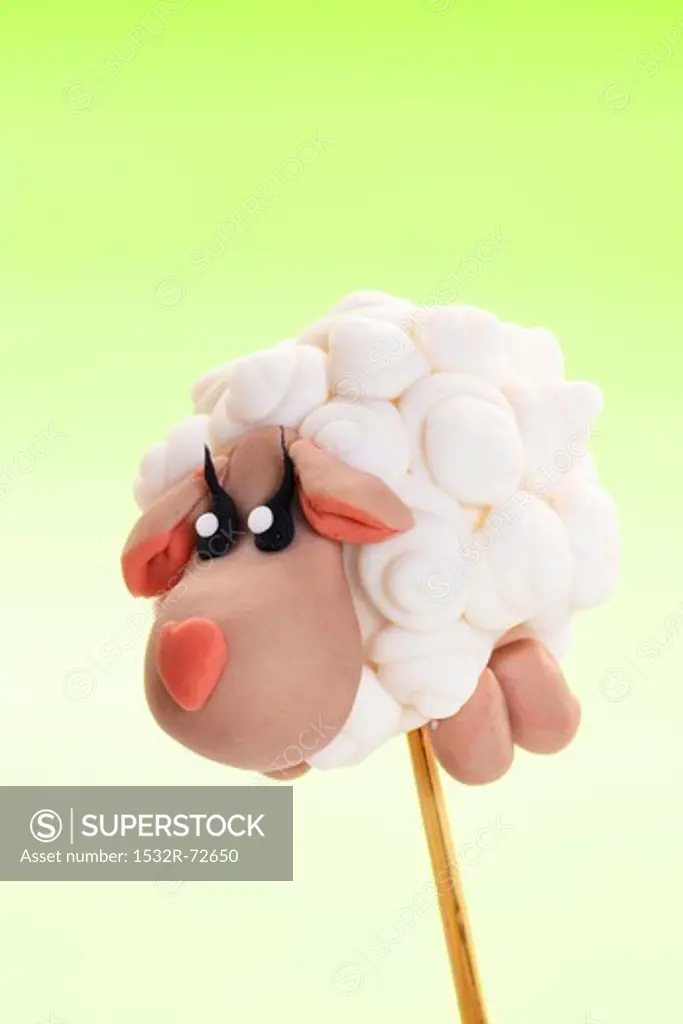 A cake pop decorated to look like a sheep