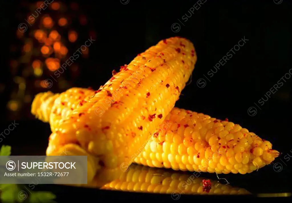 Corn on the cob with red peppercorns