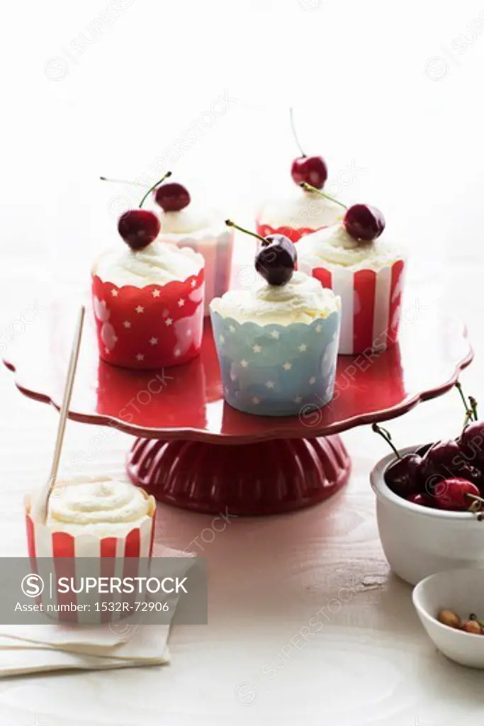 Mousse topped with cherries in small cases