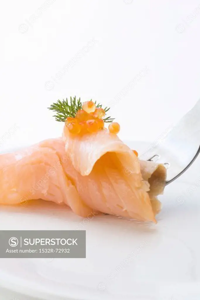 Smoked salmon topped with caviar, on a fork