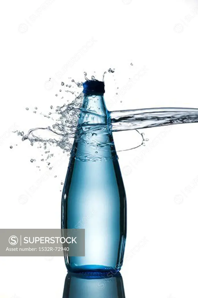 A splash hitting a bottle of water
