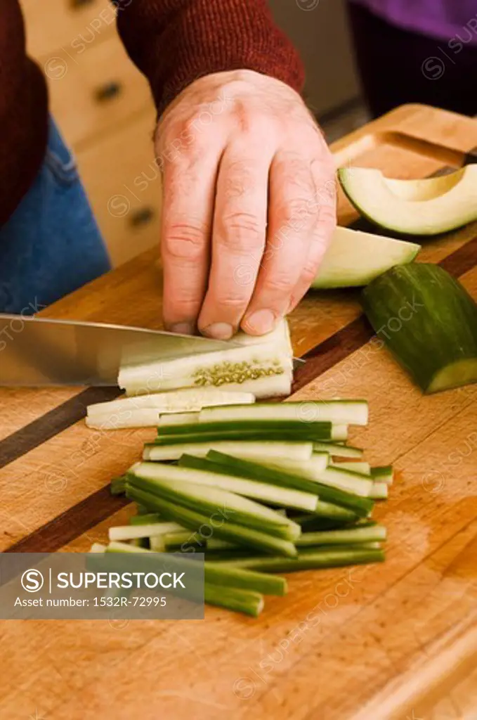 Man Slicing Cucumber into Sticks, 5/16/2013