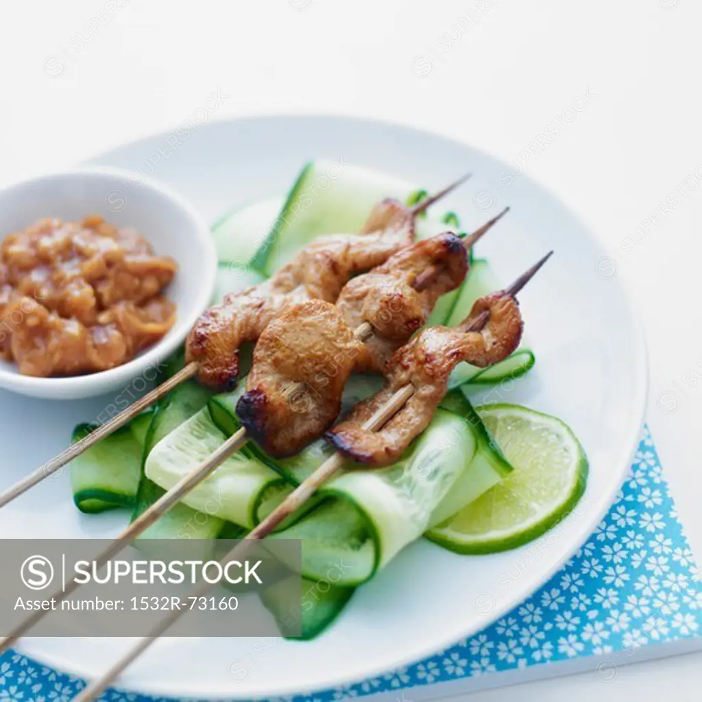 Skewers of chicken, served with cucumber slices and a satay side-dish, 8/2/2013
