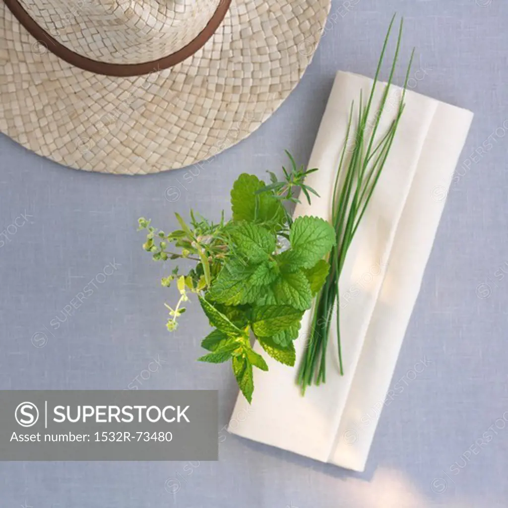 Fresh garden herbs with a napkin and a straw hat, 8/21/2013