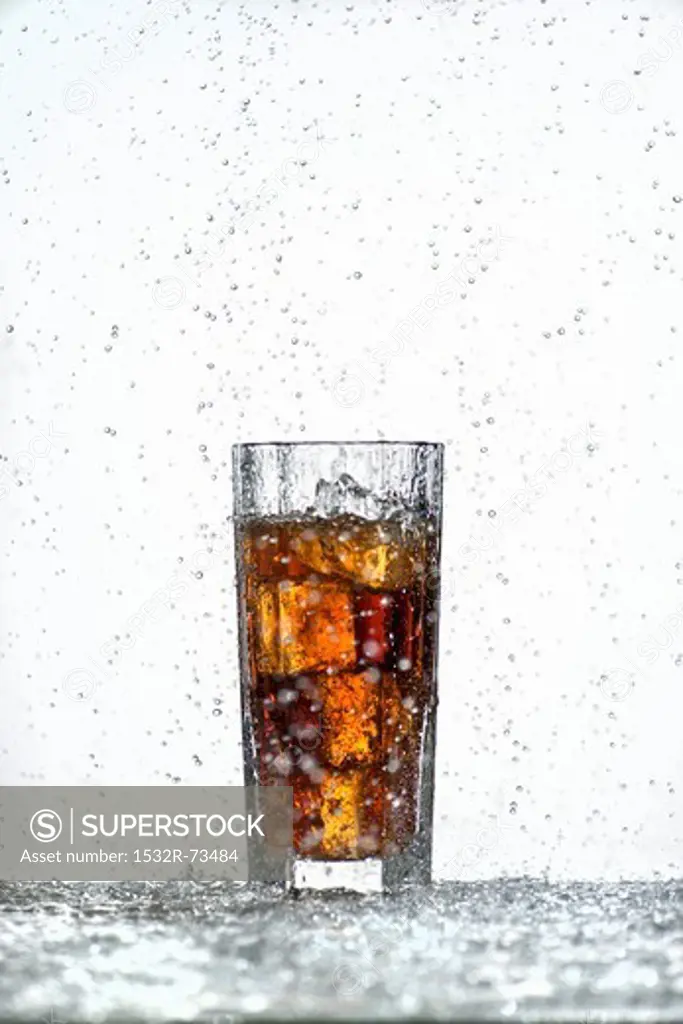 A glass of cola with ice cubes in a rain shower, 8/21/2013