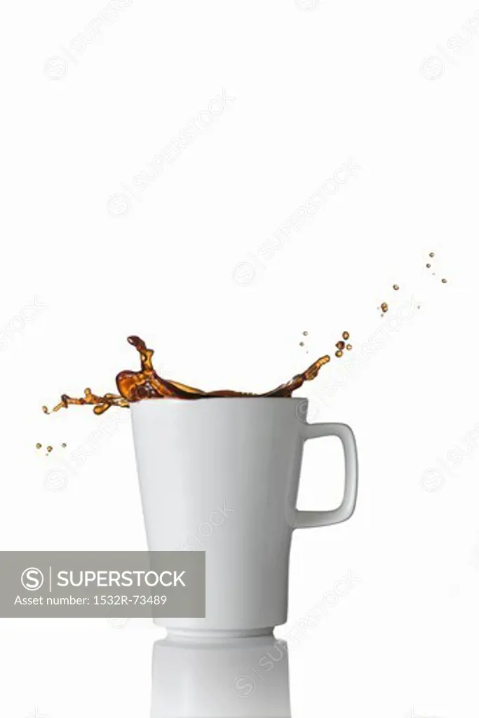 Black coffee splashing out of the mug, 8/21/2013