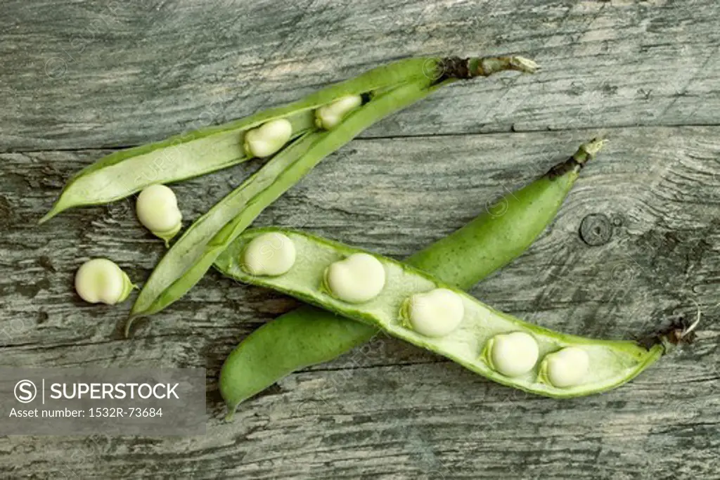 Broad beans in the pod on a wooden surface, 8/23/2013