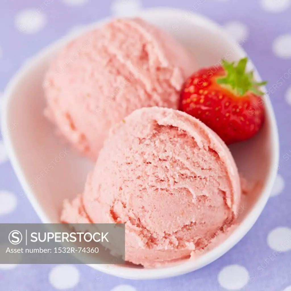 Two scoops of home-made strawberry ice cream with a fresh strawberry, viewed from above, 9/9/2013