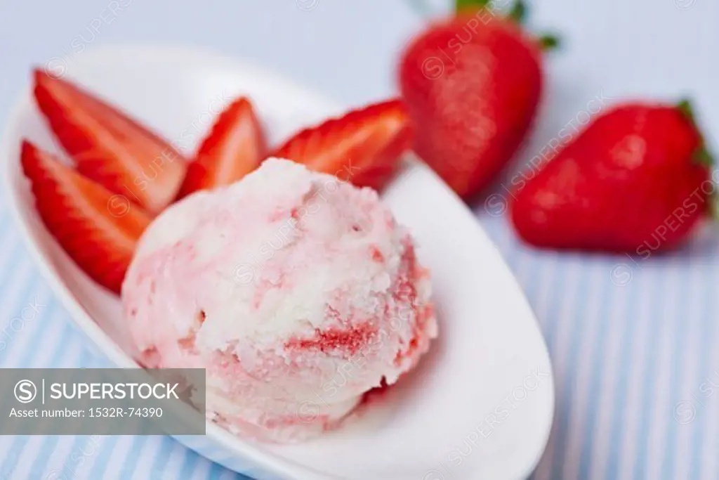A scoop of frozen yoghurt with strawberries in a shallow dish, 9/9/2013