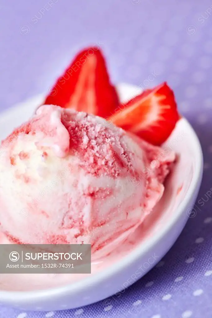 A scoop of frozen yoghurt with strawberries in a shallow dish, 9/9/2013