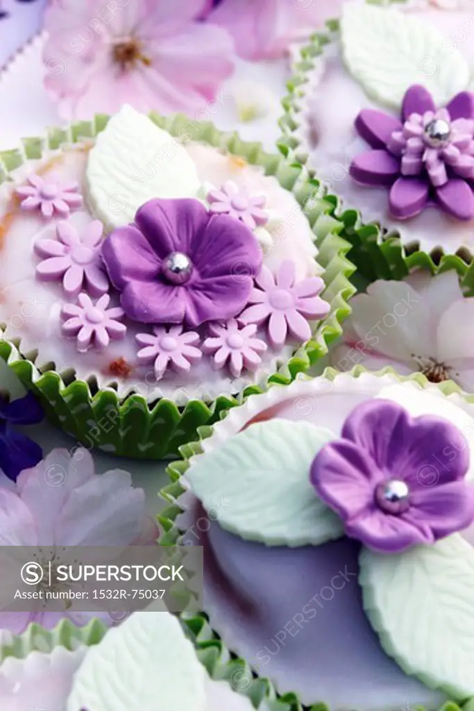 Muffins decorated with glacé icing and purple sugar flowers, 9/23/2013