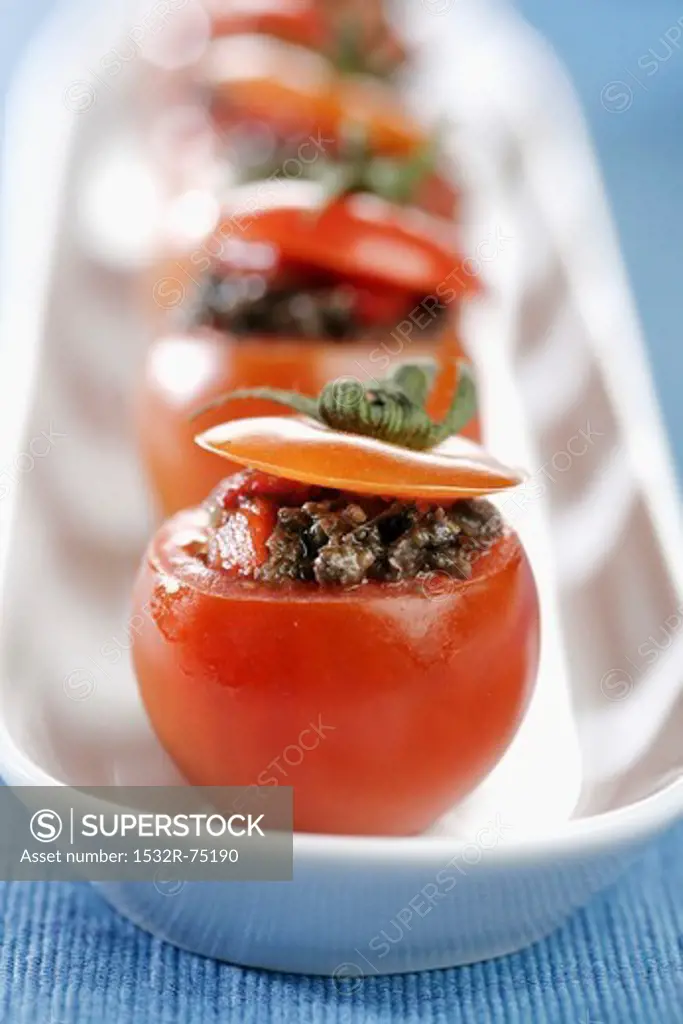 Detail of cherry tomatoes stuffed with tapenade of peppers (vertical) *** Local Caption *** Detalle de tomates cherry rellenos de tapenade de piquillos (vertical), 9/26/2013