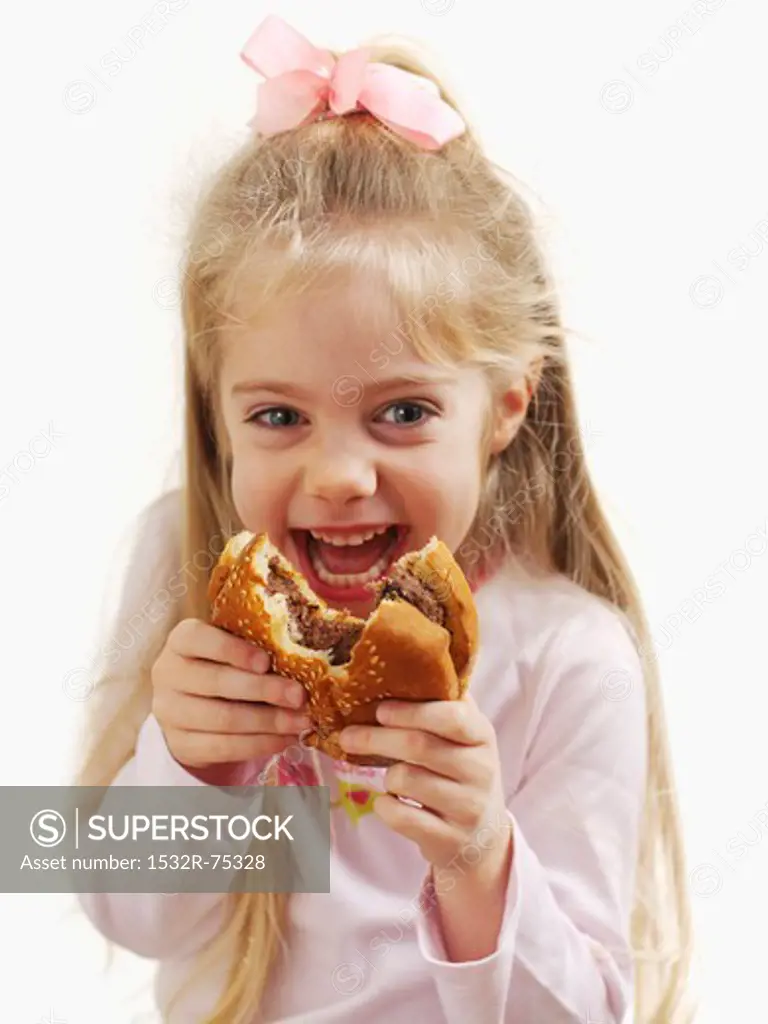 A small girl holding a hamburger, 9/30/2013