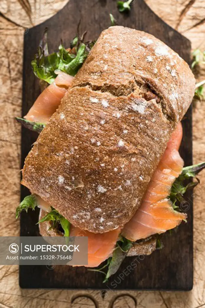 A smoked salmon and lettuce sandwich on a chopping board, 10/24/2013