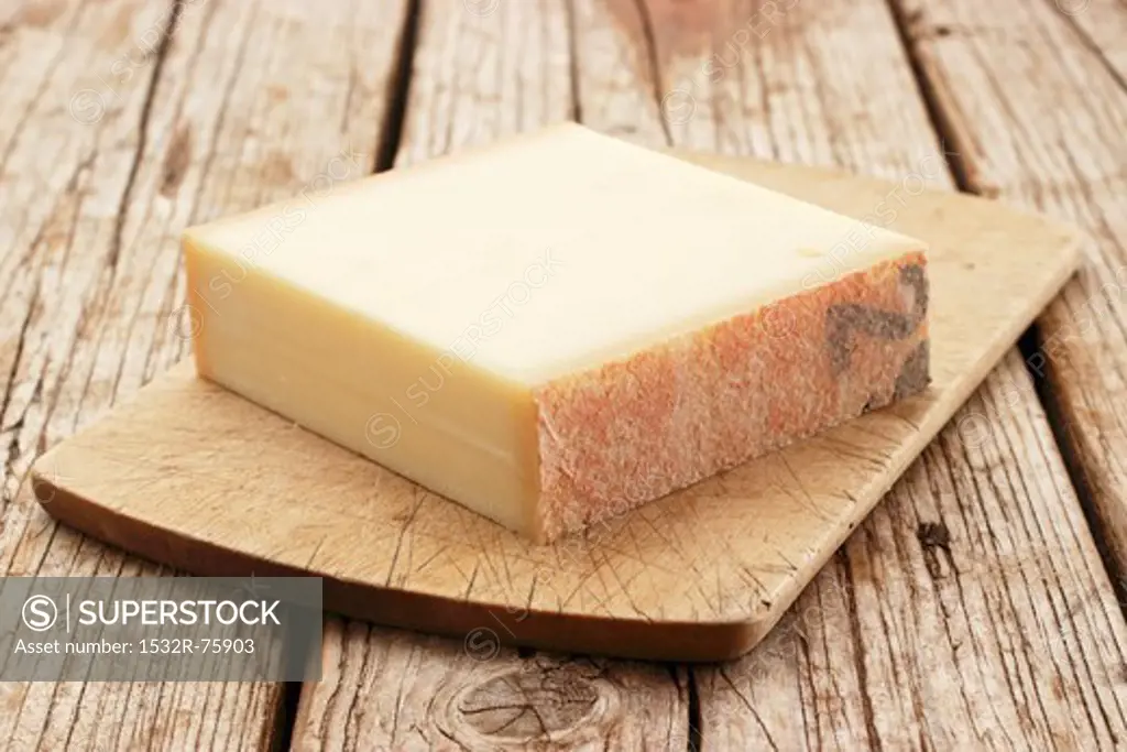 A chunk of Gruyère cheese on a chopping board, 10/24/2013